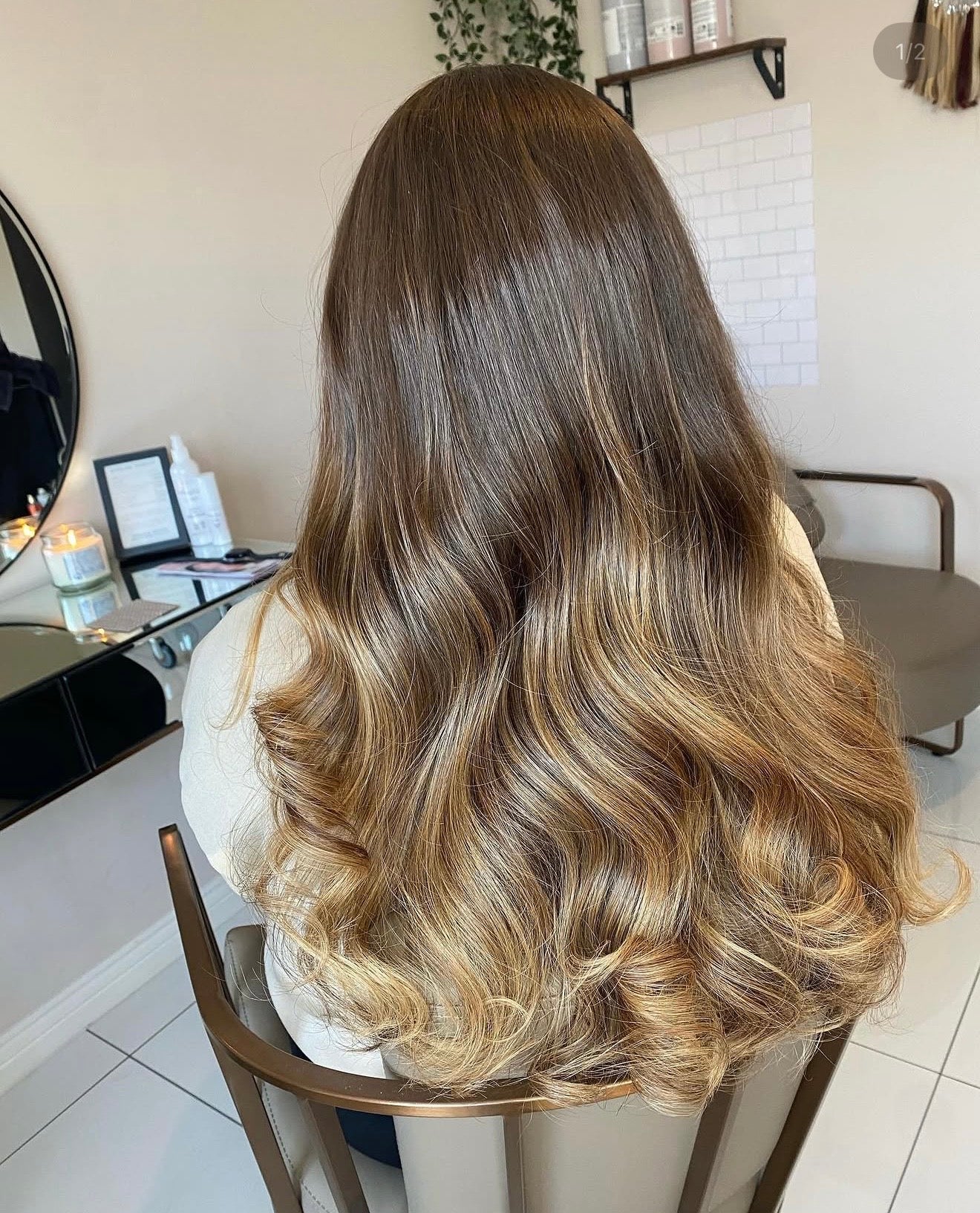 Person with wavy, ombre hair in a salon setting